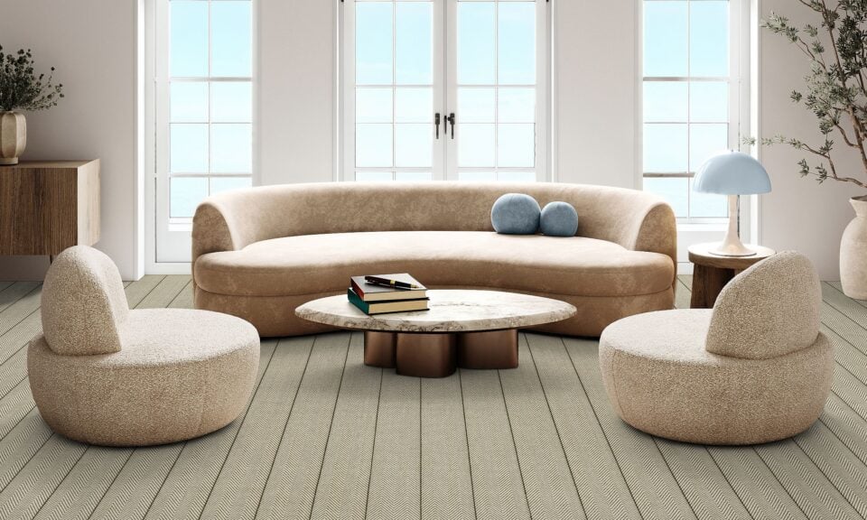 Spacious and airy boho chic living room with curved sofa and natural light from large windows. 3d render